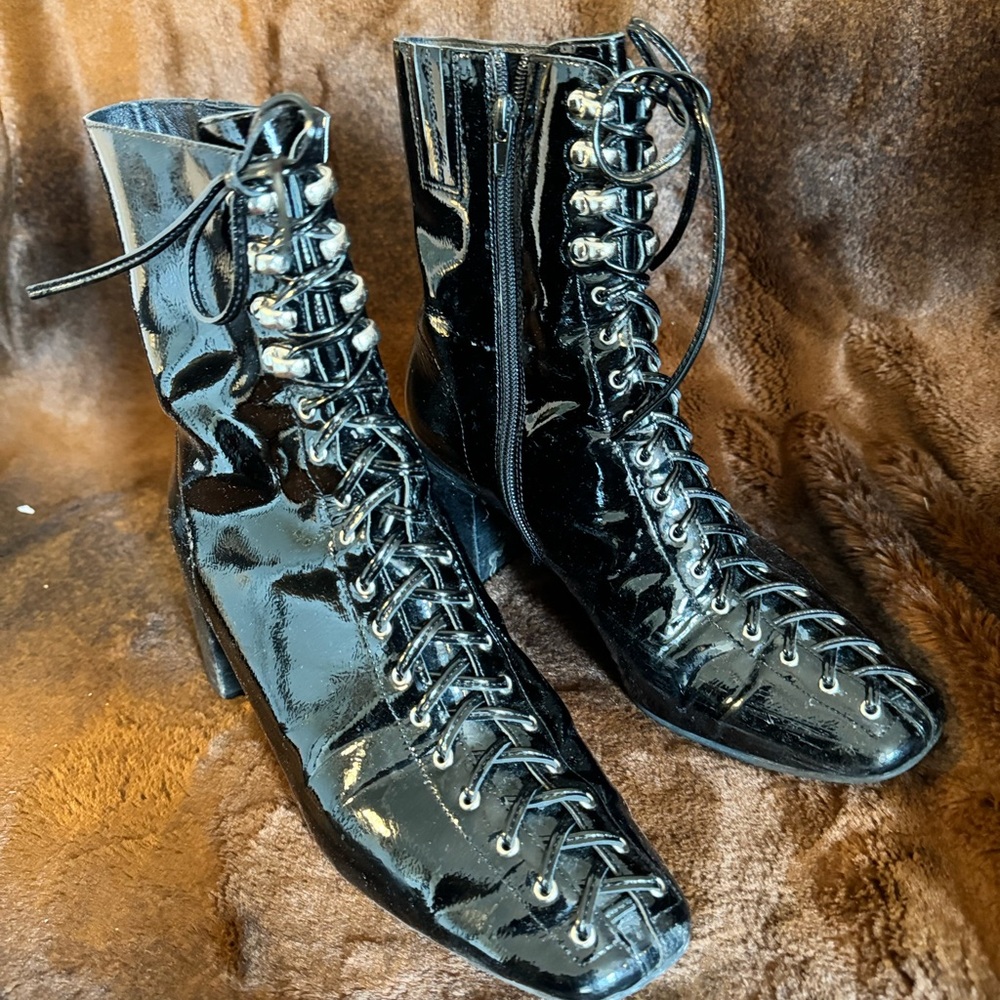 Size 10 patent leather lace up booties with a heel.